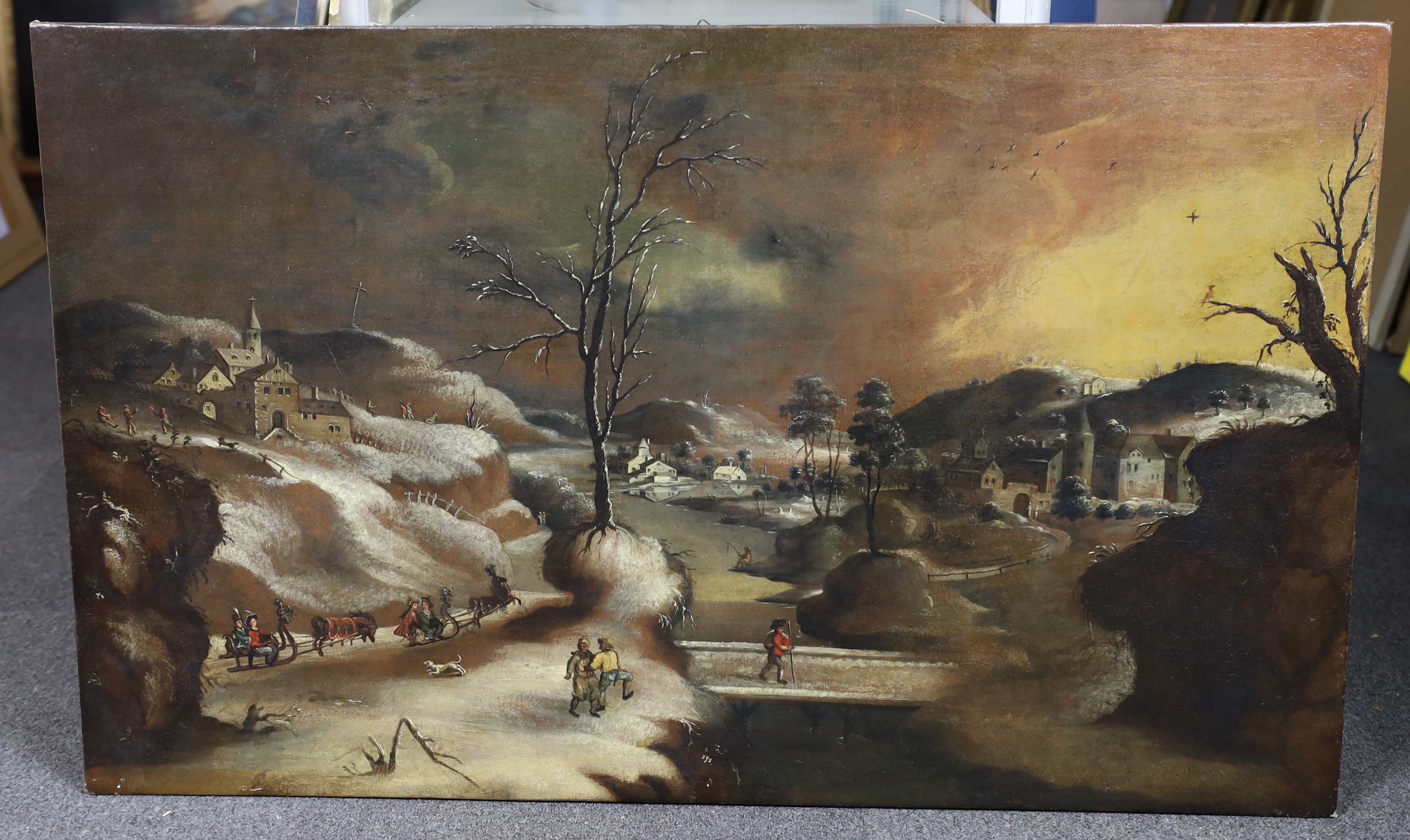 17th century Flemish School, oil on canvas, Figures in a winter landscape, 69 x 112cm, unframed